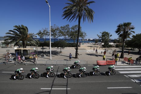 Caja Rural team cycle past palm trees
