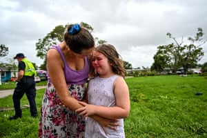 a mother comforts her crying daughter