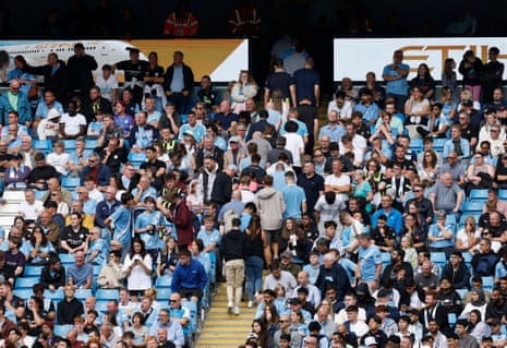 Manchester City fans leave the stadium before the end of the match.
