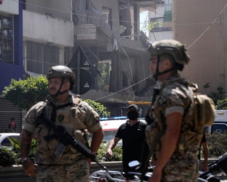 Lebanese soldiers stand guard at the site of an Israeli airstrike that struck an apartment in Dahiyeh, Beirut's southern suburbs.