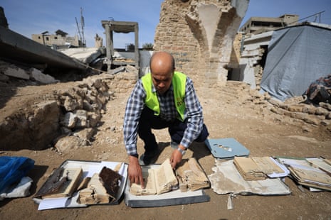 The ancient manuscripts department of the Great Mosque of Omar library, which was heavily damaged in the Israeli attacks of the Gaza Strip, work to recover manuscripts from the Ottoman and Mamluk periods from under the rubble in Gaza City.