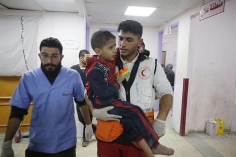 Injured Palestinians, including children, are brought to Al-Aqsa Martyrs Hospital for medical treatment following Israeli attacks in Deir al-Balah.