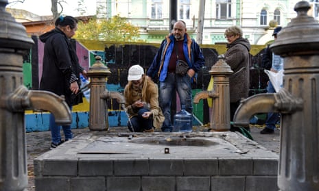Kyiv, Ukraine, October 31, 2022. People take water from a pump.
