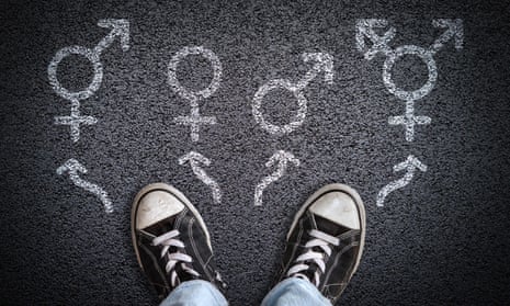 A person standing on asphalt road with gender symbols of male, female, bigender and transgender