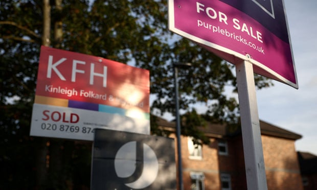 Estate agent signs attached to railings