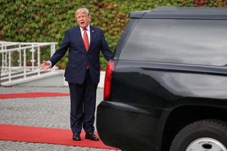 Trump stood next to his car speaking to media who are out of shot.