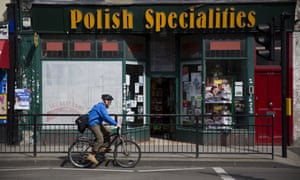 A man cycles past a Polish Specialities shop in London.
