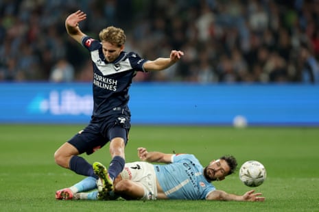 Victory’s Ryan Teague is challenged by City’s Mathew Leckie in the A-League Men grand final.