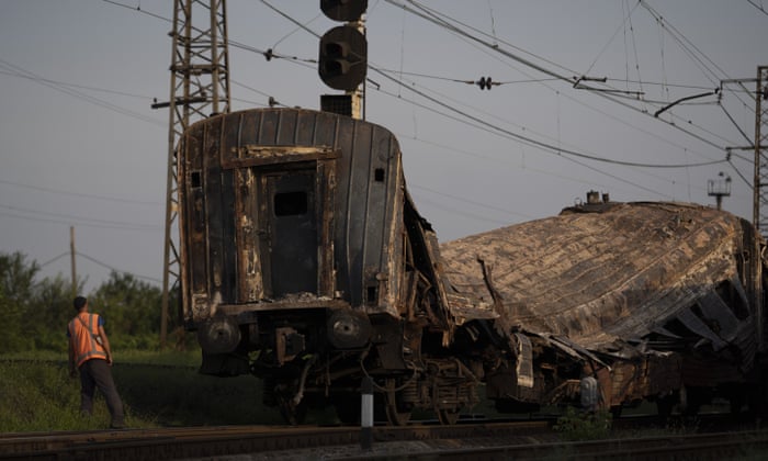 A railway worker looks at a heavily damaged train after a Russian attack on a train station on Wednesday.