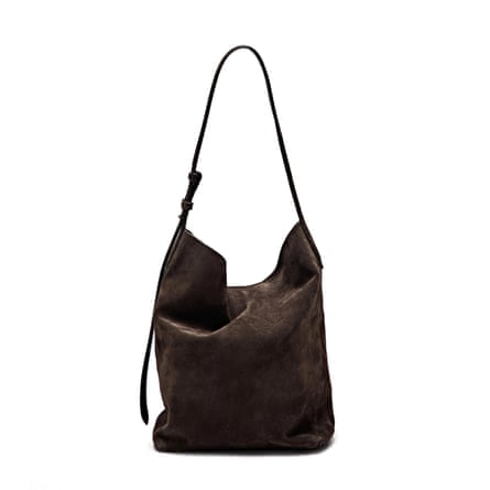 A brown suede leather bucket bag on a white background