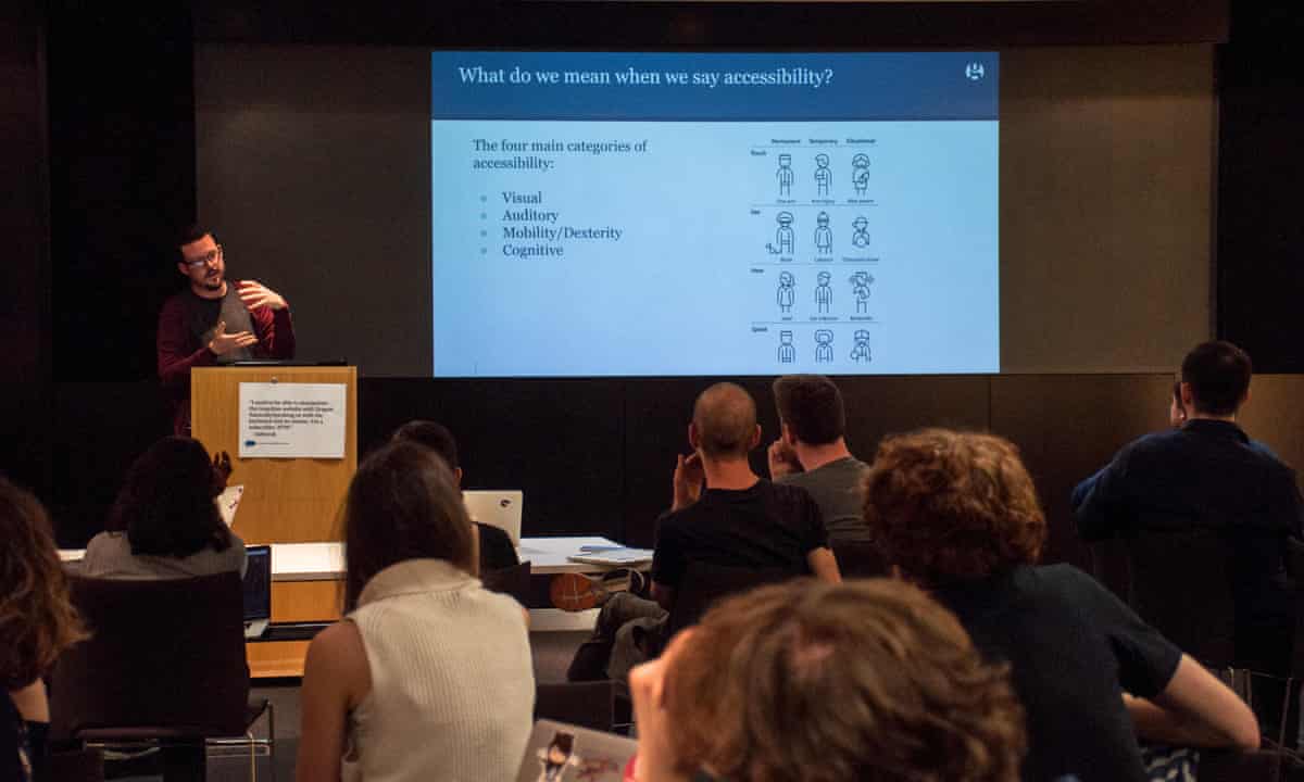 Digital Tech Time on Accessibility Awareness: A member of the Guardian Accessibility Working group stands at a lectern, presenting a slide deck. The screen shows a diagram demonstrating the types of Accessibility requirements