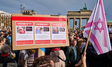 Israel-Hamas war live: White House promises ‘continued flow’ of Gaza aid as Israel steps up airstrikes in north of strip | Israel-Hamas war 2 Photographs of those missing after Hamas’ attack on Israel on 7 October are displayed by those rallying in support of Israel in front of the Brandenburg Gate in Berlin.
