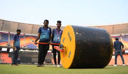Groundstaff roll the pitch at the Narendra Modi Stadium during an India nets session on Friday