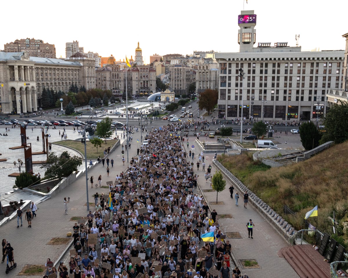 Protesters carry placards as they march during a rally calling for a reform of the defence sector and the reinstatement of the young and tech-savvy defence minister Mykhailo Fedorov, who was sacked a mounth ago, in central Kyiv.