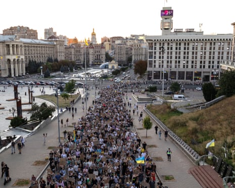 Protesters carry placards as they march during a rally calling for a reform of the defence sector and the reinstatement of the young and tech-savvy defence minister Mykhailo Fedorov, who was sacked a mounth ago, in central Kyiv.