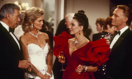 Une scène de Dynasty, 1986, avec, de gauche à droite, John Forsythe, Linda Evans, Joan Collins et Christopher Cazenove.  Gabrielle Beaumont a rejoint la série vers la fin de la première série du feuilleton et a suggéré Collins pour le rôle d'Alexis Carrington.