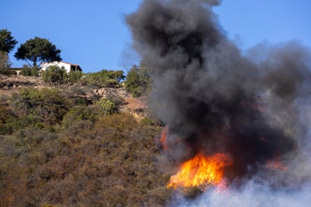 Flames from the Alisal fire burn close to a home near Goleta, California.