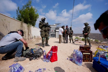 Activists trying to deliver basic supplies to three Palestinian families under siege by settlers in Qusra