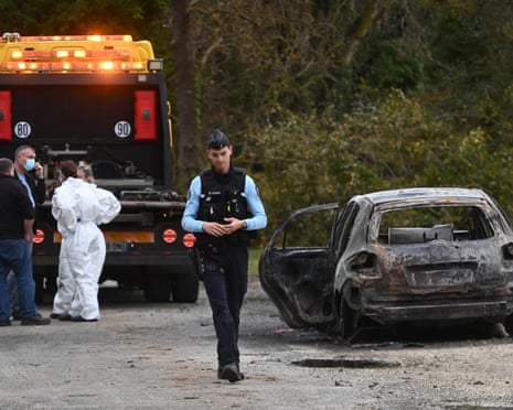 Forensic police and French gendarmes inspect the site where a burnt car was found in Saint-Pierre-d'Oleron on November 5, 2025, following an incident in which a car rammed into pedestrians and cyclists on the French Atlantic island of Oleron.