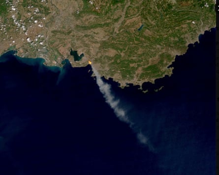 A satellite image provided by Meteo France shows smoke from the wildfire billowing out to sea