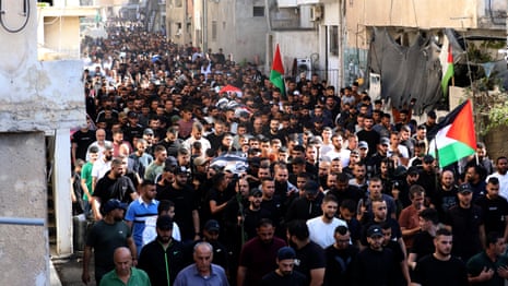 Crowds attend funeral procession for Palestinians killed in West Bank raid – video 