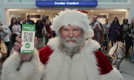 still from Tesco Xmas advert showing Santa Claus with NHS covid pasport