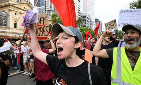 Transgender rights supporters are held back by police during a rally, involving opposing neo-Nazi protesters, outside Parliament House in Melbourne.