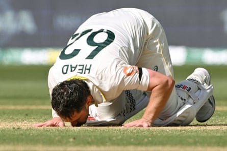 Travis Head kisses the pitch at Adelaide Oval as he celebrates scoring a century on day three of the third Ashes Test.