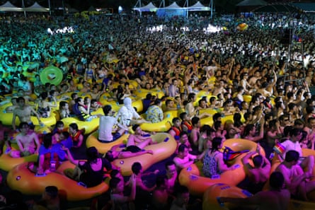 People enjoy a music party inside a swimming pool at the Wuhan Maya Beach Park, in Wuhan, following the coronavirus disease (COVID-19) outbreak, Hubei province, China August 15, 2020.