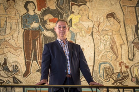 Frank Balzer standing in front of a mural