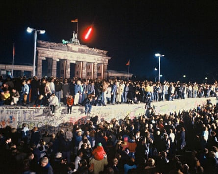 Large crowd climb onto the Berlin Wall