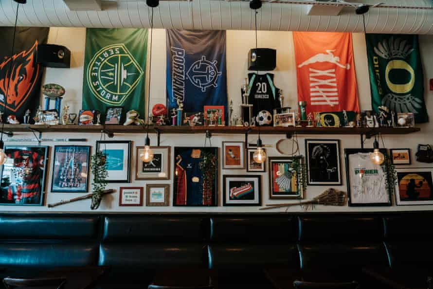 A wall of the bar holds various women's sports memorabilia.