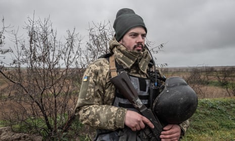 A Ukrainian soldier guards the banks of the Dnipro in the Kherson region.