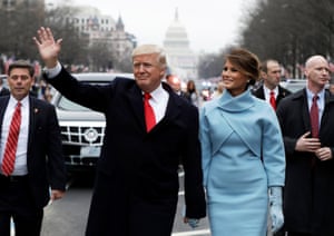 Donald Trump waves as he walks with first lady Melania Trump during his inauguration parade in Washington, January 2017.