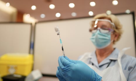 A nurse prepares the vaccine
