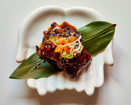 Kawan’s choco-orange ribs arranged on a leaf on a bowl shaped like cupped palms
