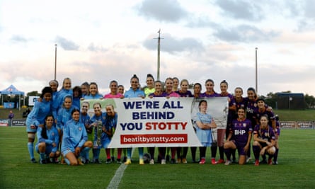 Players from Melbourne City and Perth Glory show their support for Stott before a match in March.