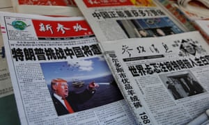 Chinese news papers showing US president Donald Trump at a newsstand in Shanghai.