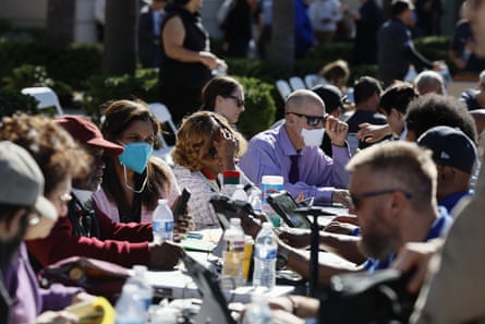 rows of people sitting down at tables outside