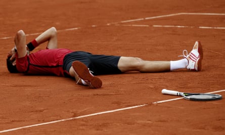 Djokovic falls to the ground after clinching the title and a career grand slam.