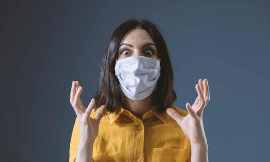 Masked woman showing stress (posed by model)