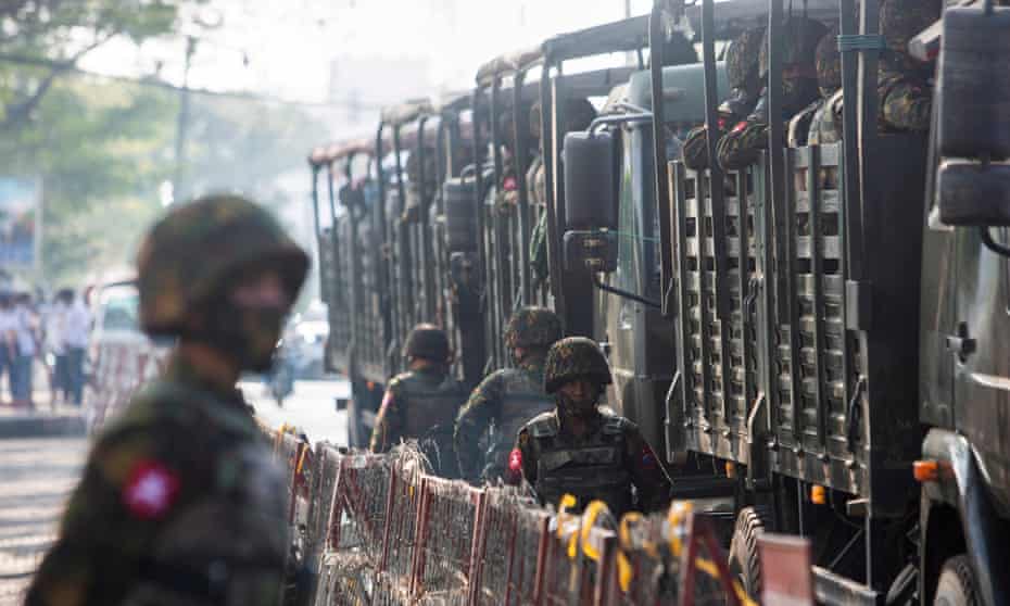 File photo of soldiers standing next to military vehicles in Yangon, Myanmar