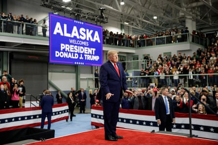 Donald Trump stands in an arena