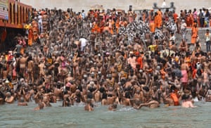 Uttarakhand, India. Holy men take the holy dip in Ganga river during the Kumbh Mela royal bath