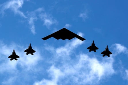 The five planes silhouetted against a blue sky