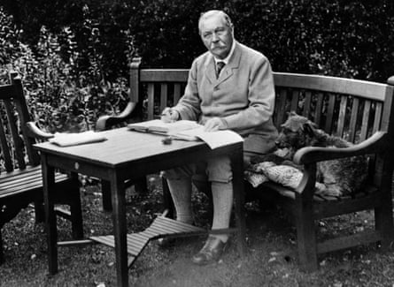 Sir Arthur Conan Doyle sits on an outdoor bench to write at a table in a garden