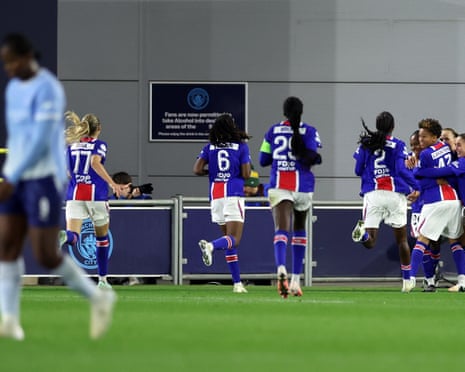 Tara Elimbi Gilbert is embraced by her PSG teammates after scoring a late equaliser