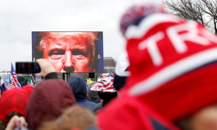 Donald Trump’s face was projected on a screen as he spoke to supporters at the 6 January rally in Washington.