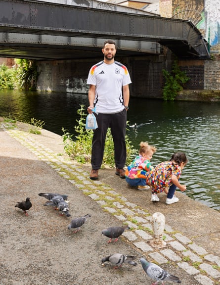 Lanre Bankare with his daughters, by a canal, feeding ducks.