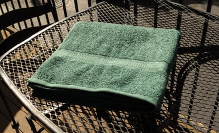 The Mainstays Cotton Bath Towel from Walmart on a table outside